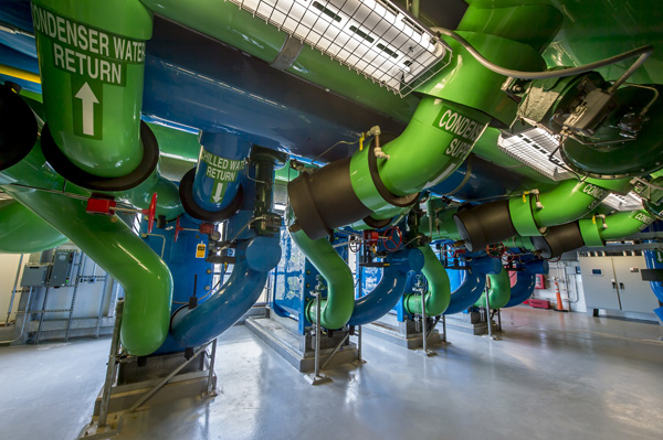 Water Piping in an academic facility's central utility plant labeled condenser water return, condenser supply, chilled water return