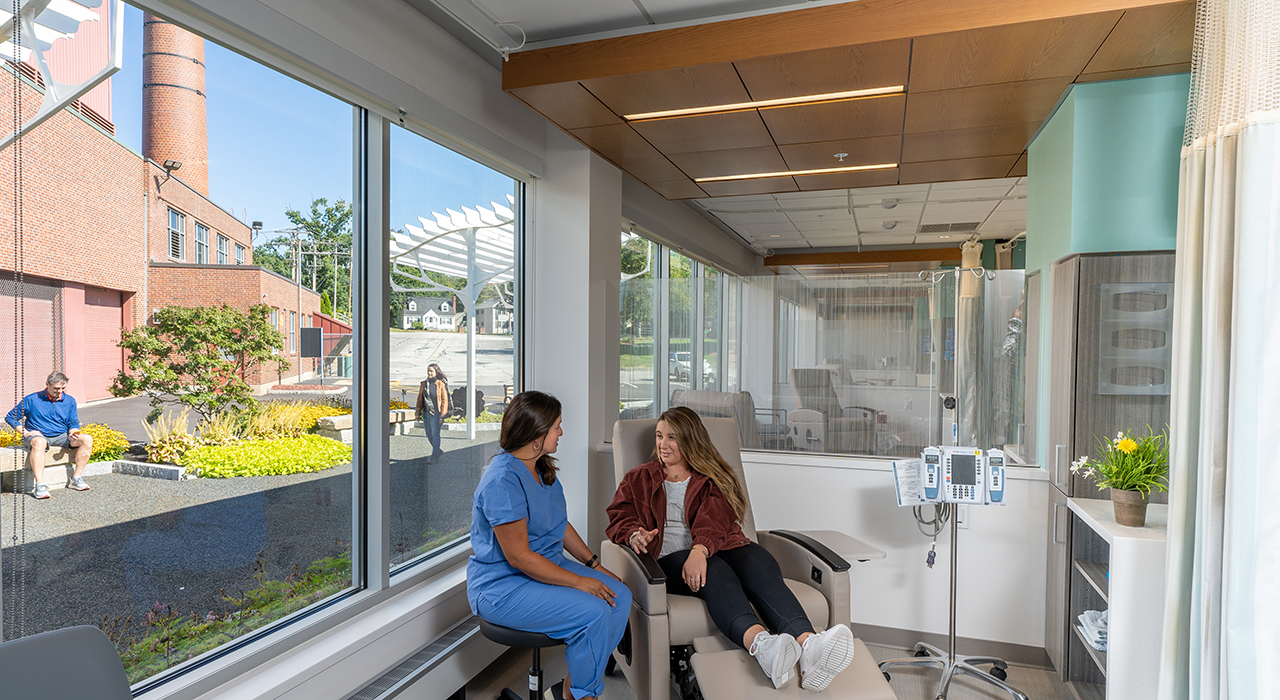 Elliot Hospital, Solinsky Center for Cancer Care at The Elliot | Manchester, NH; Photographer David Pires; interior photograph of the oncology infusion treatment area and healing gardens on the exterior can be seen through the window