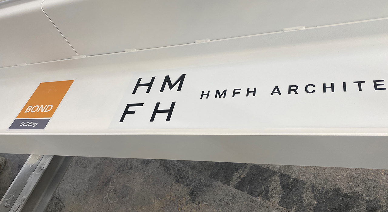 Town of Weymouth MA Maria Weston Chapman Middle School Topping Off - white topping off beam with BOND Building and HMFH Architects' logos